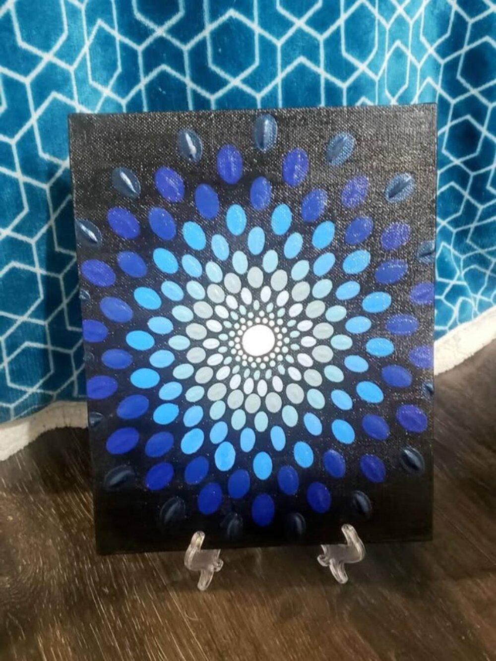 Hand painted mandala painting with a dot design.